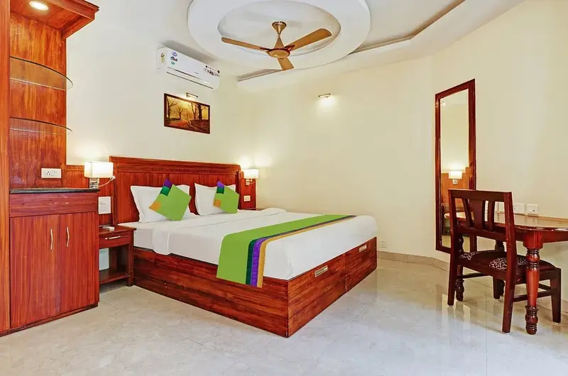 Premium AC double room with traditional wooden furniture at Treebo Trend Linchu Ayur Resort