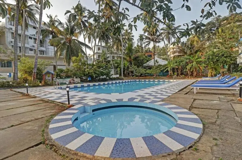 Outdoor swimming pool and relaxation area at Treebo Trend Linchu Ayur Resort Kerala
