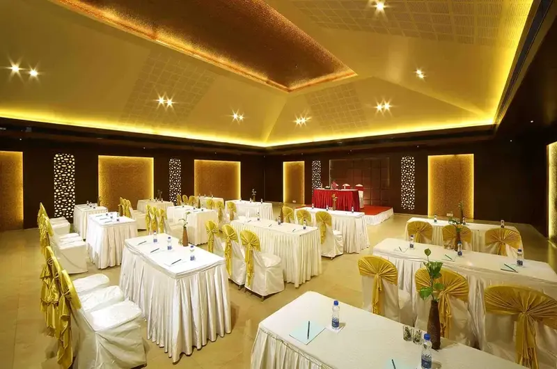 Well-appointed indoor event venue and reception hall with premium white table linens at Uday Samudra Kovalam.