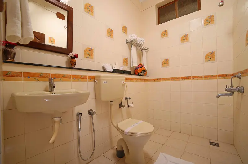 Clean modern attached bathroom interior featuring contemporary fittings at Jasmine Palace Kovalam.