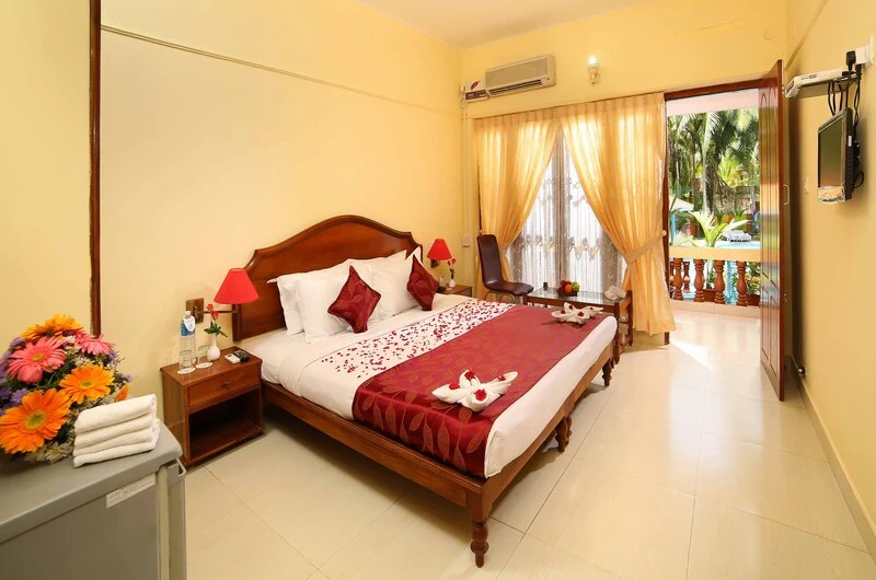 Premium double room accommodation at Jasmine Palace Kovalam featuring a private balcony.