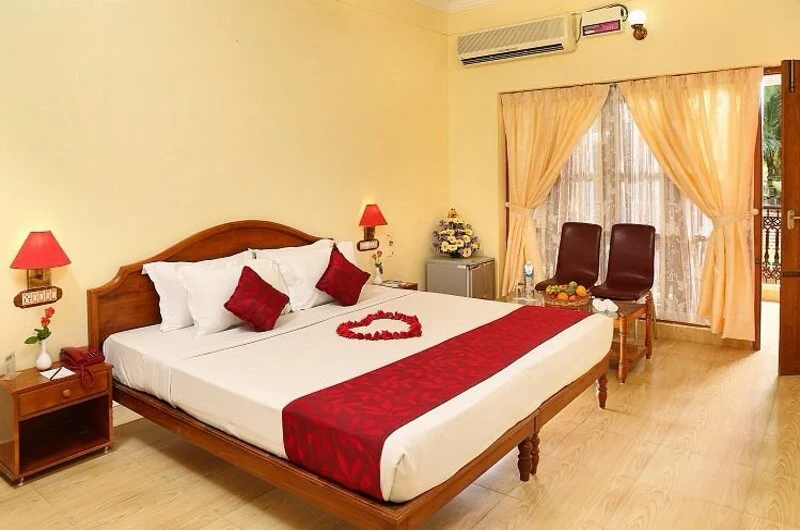 Premium air-conditioned guest room layout with elegant interiors at Jasmine Palace Kovalam.