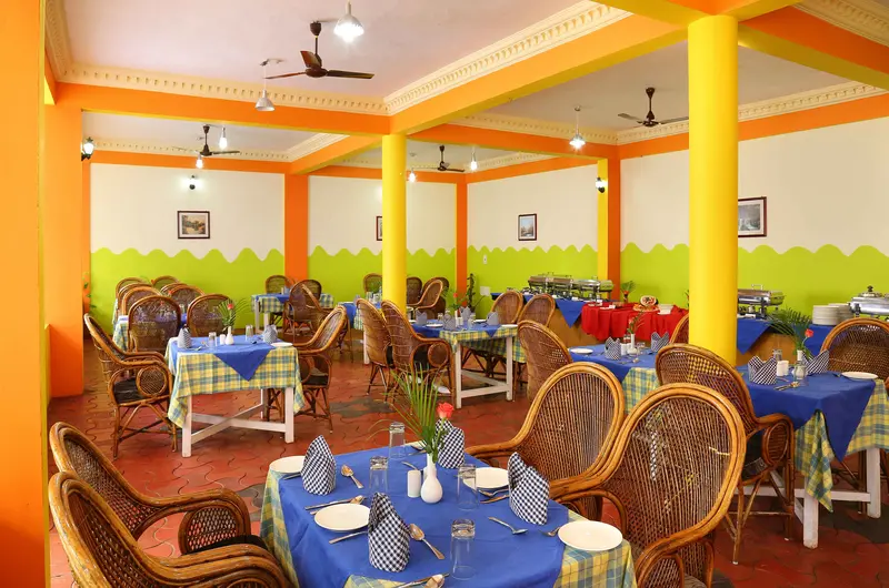 Spacious indoor dining area and multi-cuisine family restaurant at Jasmine Palace Kovalam.