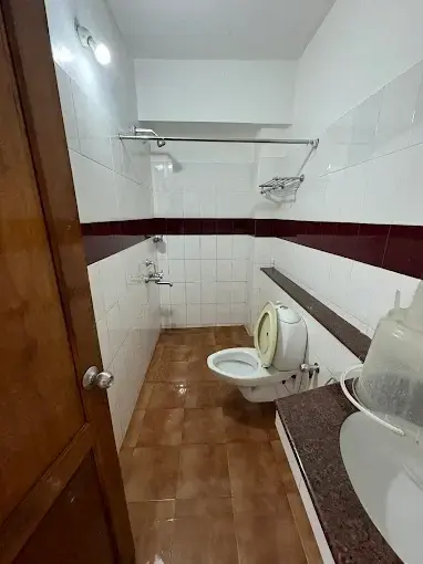 Clean attached bathroom interior with modern ceramic fixtures and tile flooring at Hotel Marine Palace Kovalam.