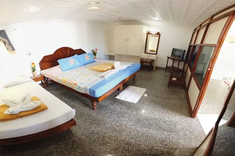 Premium double bedroom accommodation leading out to a sea-view balcony at Hotel Marine Palace Kovalam.