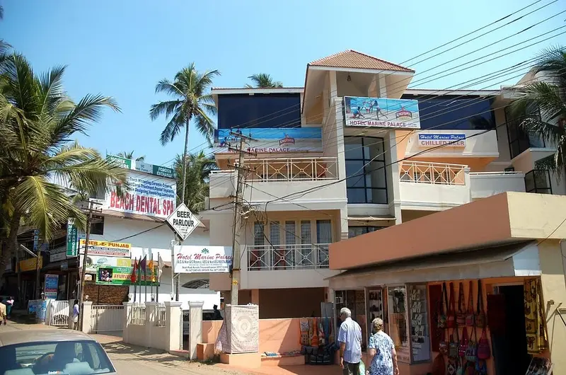 Exterior building facade of Hotel Marine Palace Kovalam featuring private guest balconies and a paved courtyard.