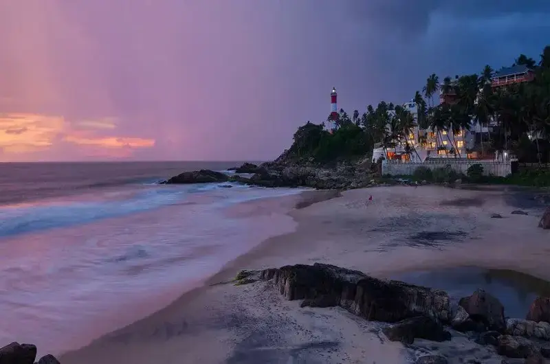 Panoramic sunset view of the Kovalam beach coastline and rolling waves from Rockholm hotel.