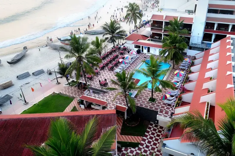 High angle view of the outdoor swimming pool and terraced building at Hotel Sea Face Kovalam.
