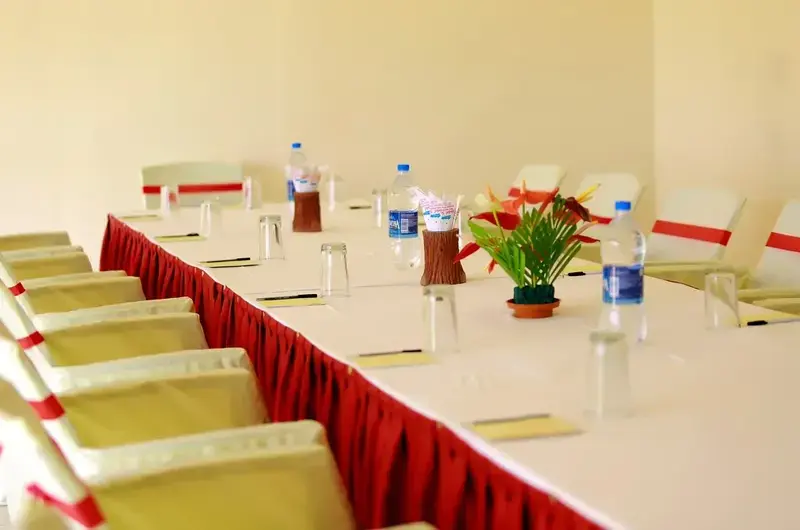 Spacious indoor conference hall setup with rows of cushioned chairs at Hotel Sea Face Kovalam.