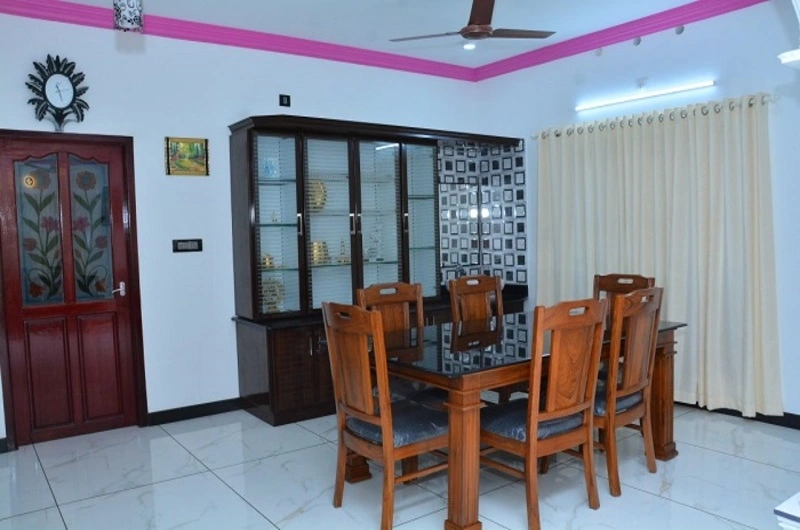 Family-friendly dining space and indoor guest seating arrangement at Bougainvillea Homestay Kovalam.