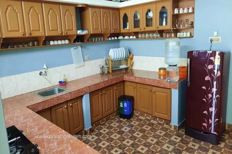 Spacious air-conditioned family room accommodation with a long vanity counter at Gokulam Homestay Kovalam.