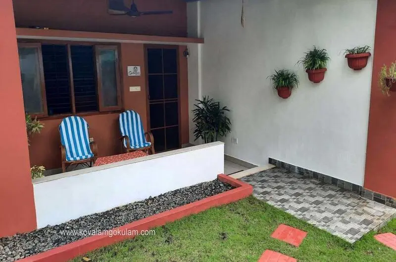 Cozy outdoor veranda sit-out area with comfortable chairs at Gokulam Homestay Kovalam.