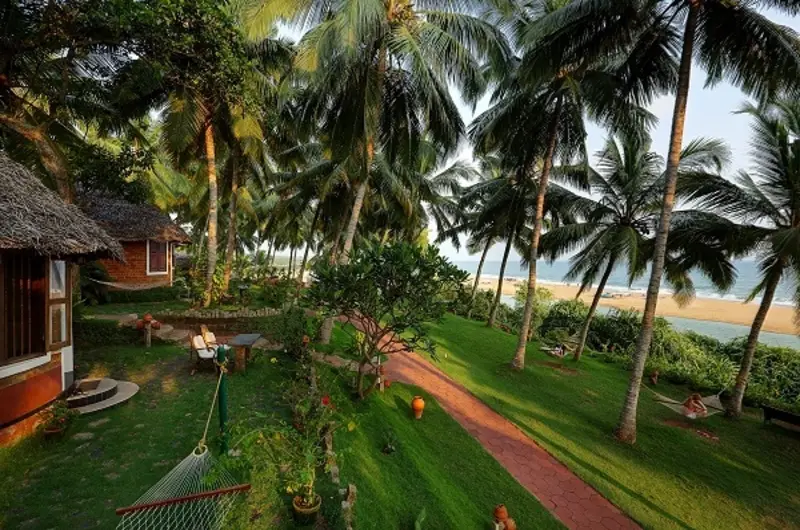 Beautifully landscaped green lawns and seaside vegetation at Soma Manaltheeram Ayurvedic Hospital & Research Centre Kovalam