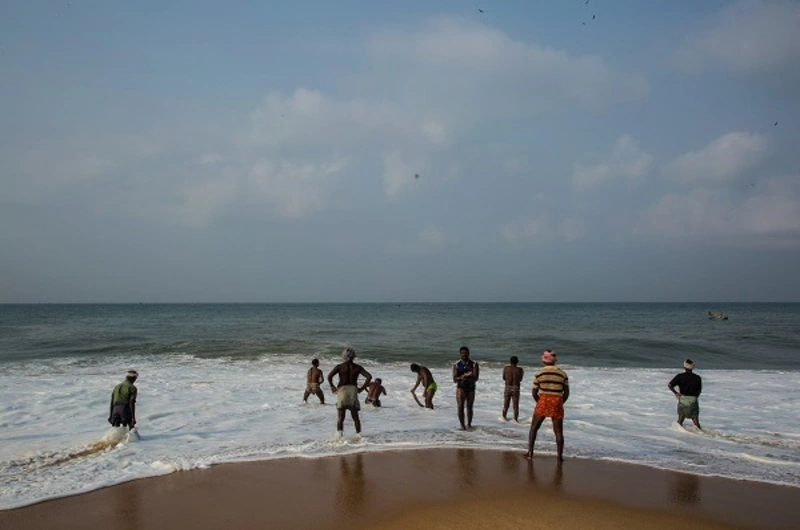 Guests enjoying the pristine beach and ocean waves near Soma Manaltheeram Ayurvedic Hospital & Research Centreview of the sandy beach and Arabian Sea coastline at Soma Manaltheeram Ayurvedic Hospital & Research Centre Kovalam