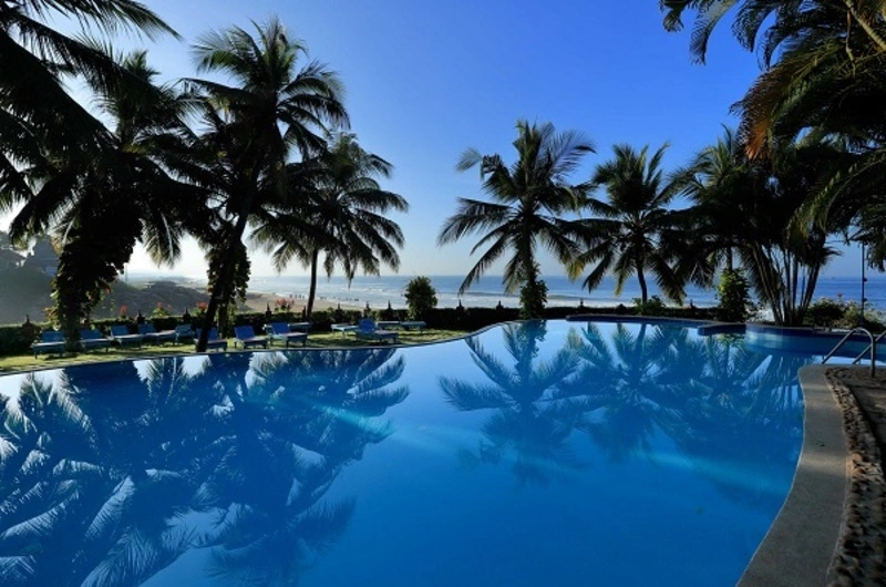 Large outdoor swimming pool overlooking the coast at Soma Manaltheeram Ayurvedic Hospital & Research Centre Kovalam