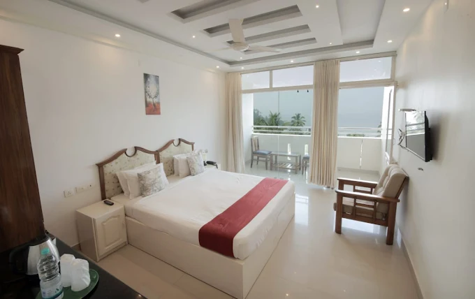 Premium twin deluxe room accommodation at Samudratheeram Beach Resort Kovalam featuring a private balcony.