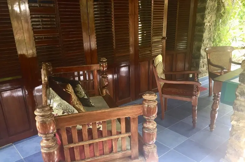 Ornate traditional Kerala style wooden bed and antique room furnishings at Maharaju Palace Kovalam.
