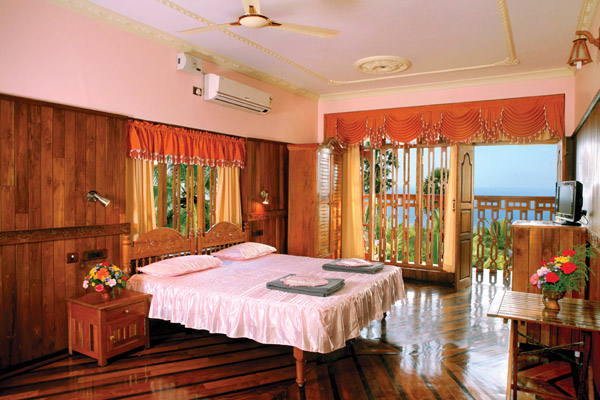 Premium wood paneled sea view room interior at Sun Tara Beach Resort Kovalam