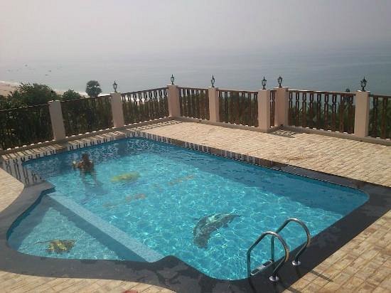 Outdoor swimming pool overlooking the coast at Sun Tara Beach Resort Kovalam