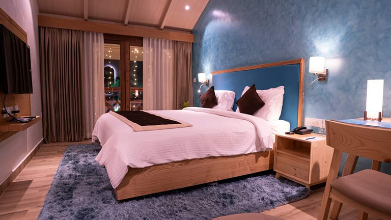 Cozy deluxe room interior with warm ambient lighting at KTDC Samudra Resort