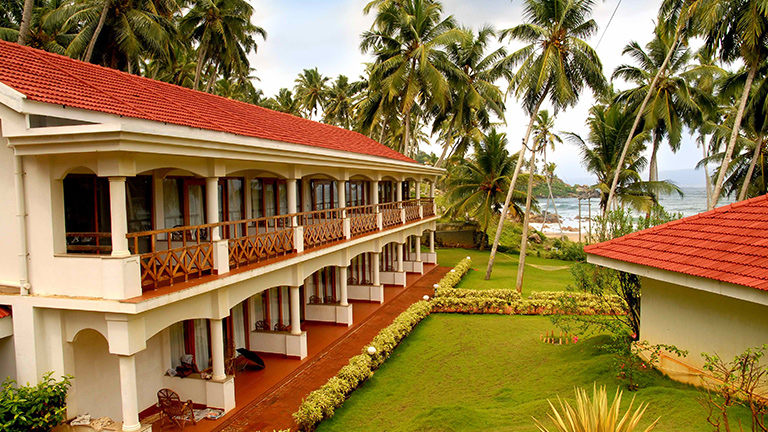 Beachfront guest room blocks and manicured lawns at KTDC Samudra Resort Kovalam