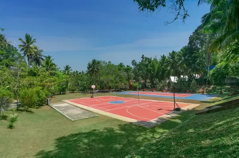 Outdoor recreational sports court surrounded by lush greenery at Estuary Island Resort