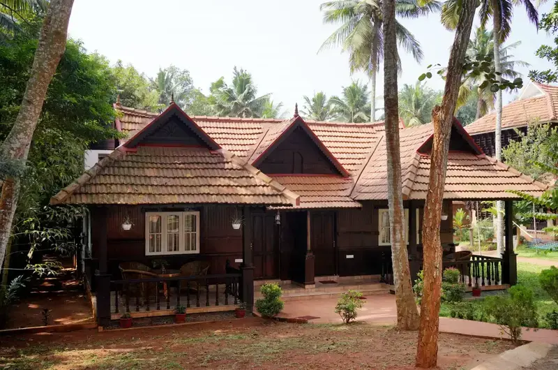 Traditional Kerala heritage wooden cottage at Gods Own Country Ayurveda Resort Kovalam