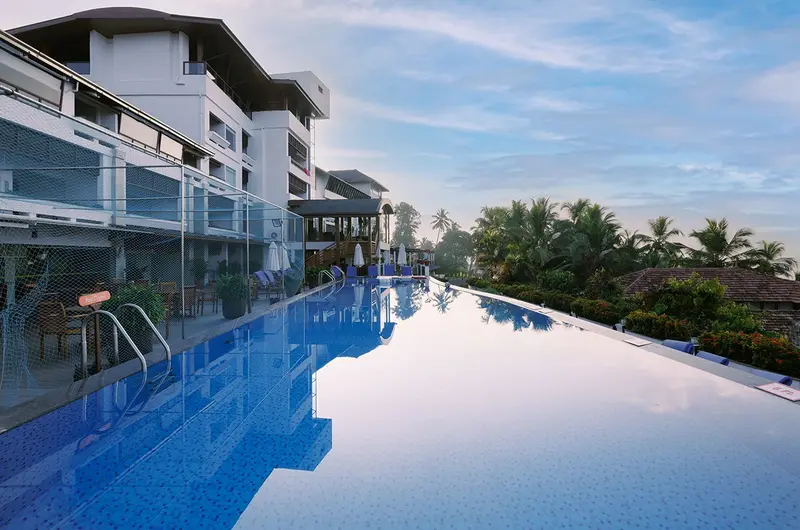 Luxury infinity swimming pool overlooking the ocean at Gokulam Grand Turtle on the Beach Kovalam