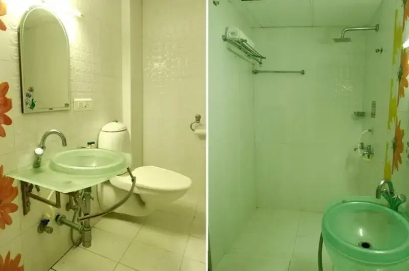Clean attached bathroom with glass shower partition at Hill and Sea View Ayurvedic Beach Resort Kovalam