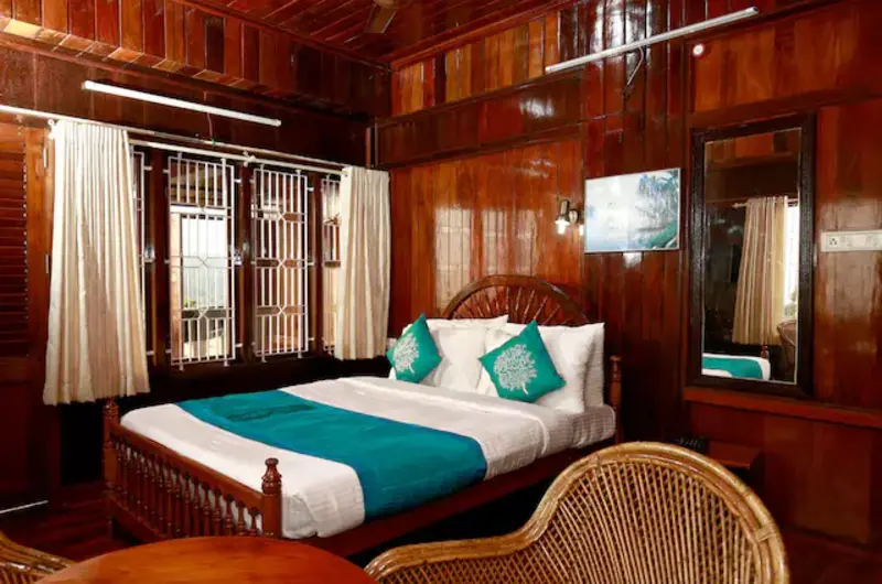 Premium wood paneled guest room featuring a double bed at Hill and Sea View Ayurvedic Beach Resort Kovalam