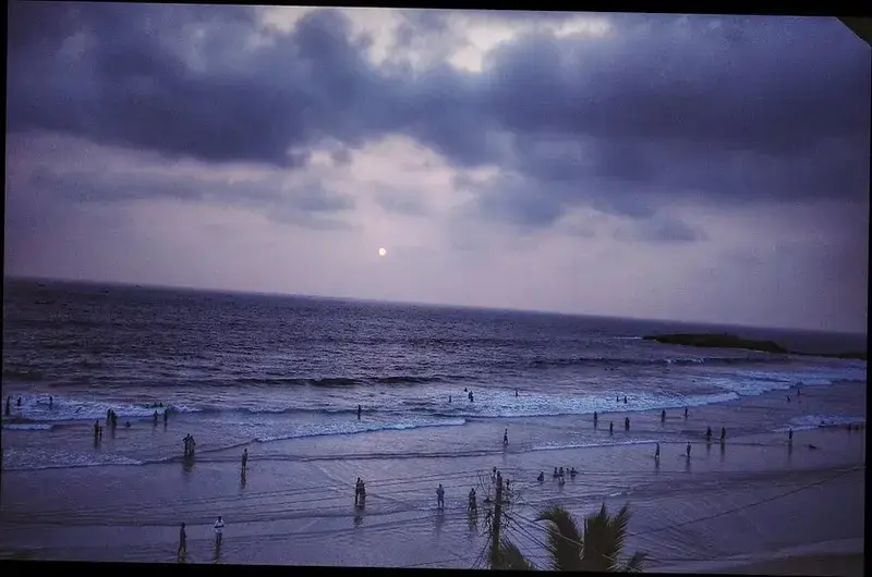 Scenic ocean waves and beach view during dusk at Orion Seaview Beach Resort Kovalam