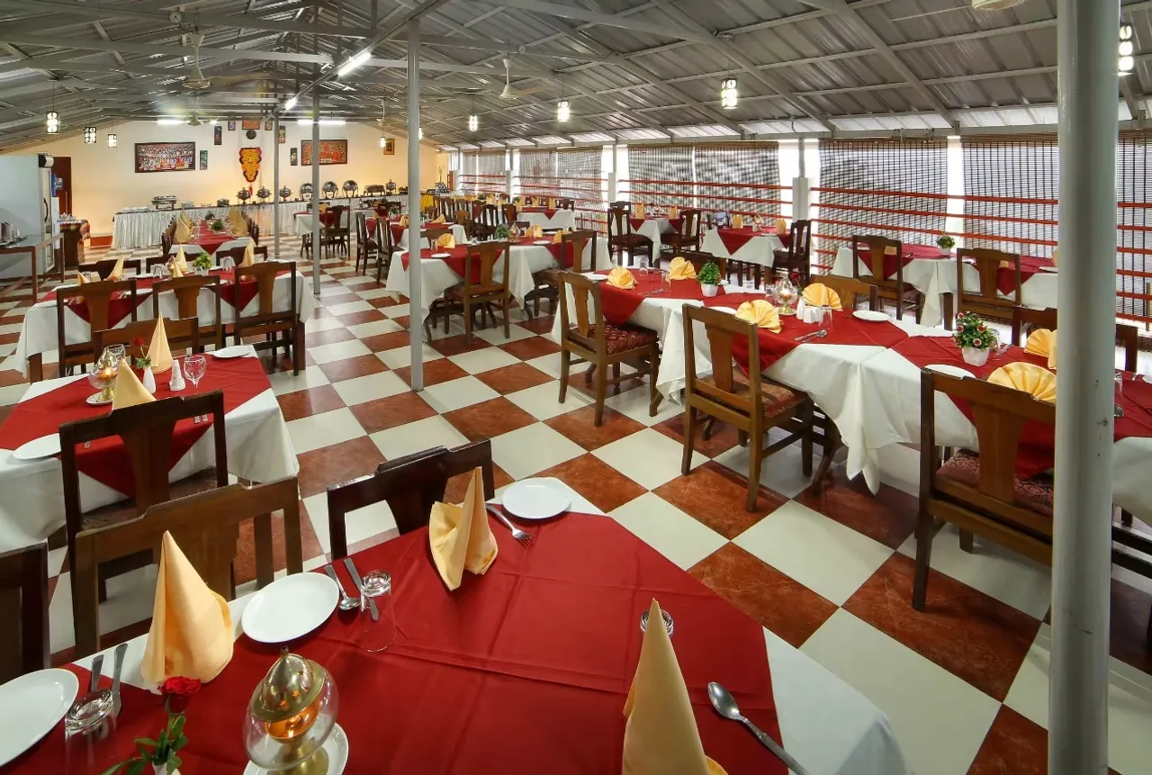 Multi-cuisine indoor family restaurant and dining space at Samudratheeram Beach Resort.