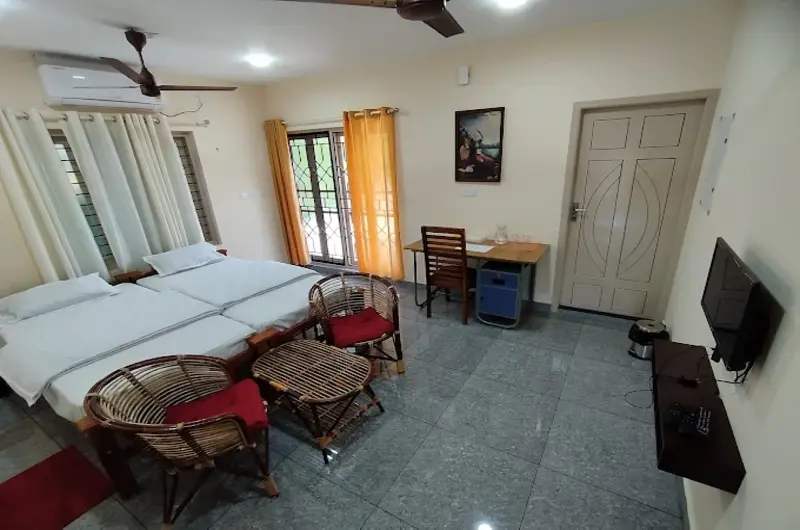 Spacious air-conditioned triple bedroom layout perfect for families at Greenview Homestay Kovalam.
