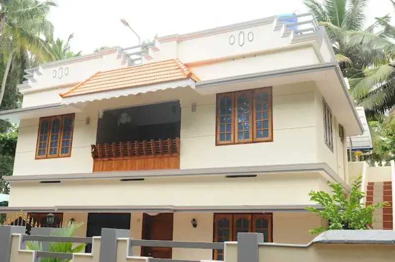 Modern multi story white residential guest house block at Jeevan Homestay Kovalam.