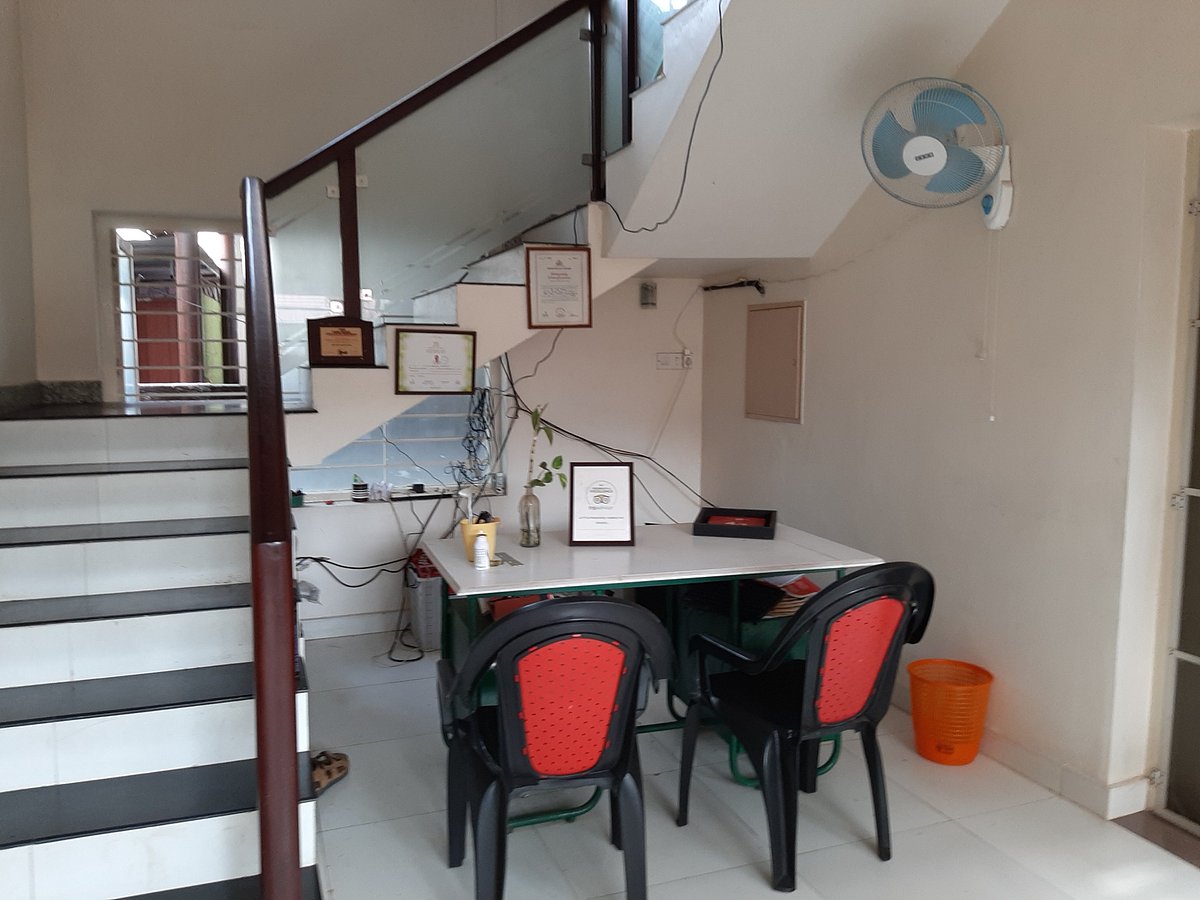 Shared guest kitchen layout and modern indoor staircase at Little Paradise Homestay Kovalam.