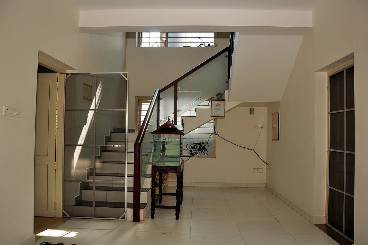 Clean indoor hallway and open ground floor utility area at Little Paradise Homestay Kovalam.