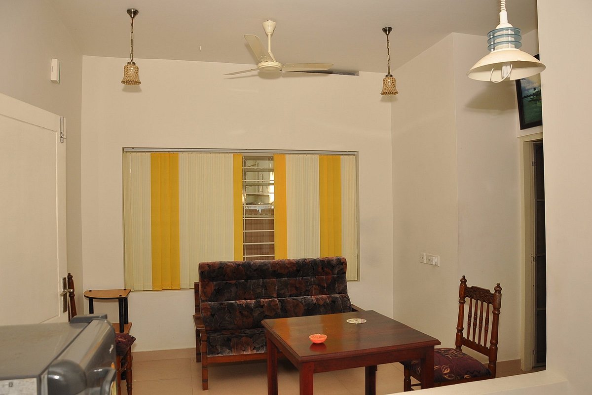 Bright common dining area and shared indoor guest space at Little Paradise Homestay Kovalam.