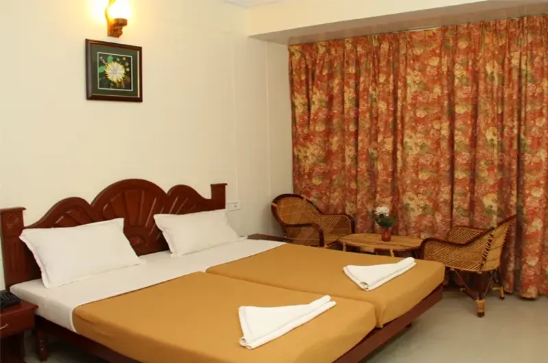 Air conditioned guest room setup with wooden paneling at Rock N Beach hotel