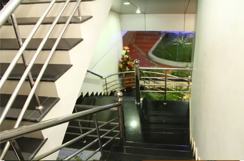 Modern indoor tiled staircase structure inside Rock N Beach hotel