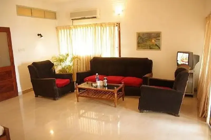 Hotel lobby reception seating area with black sofas at Raja Hotel Kovalam