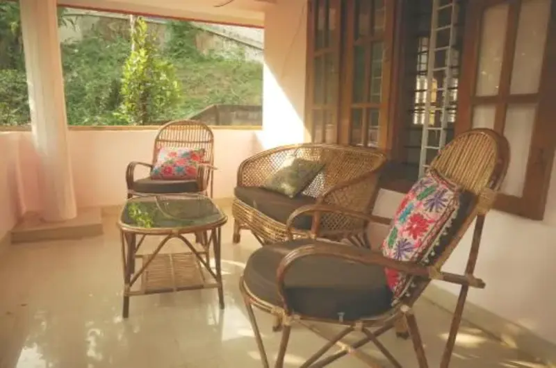 Cozy balcony veranda sitting area with bamboo chairs at Padmini House