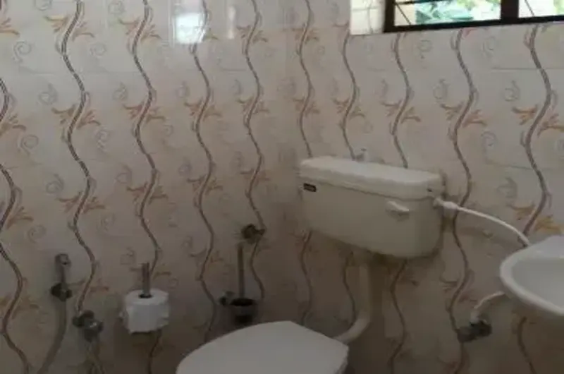 Tiled guest bathroom interior with modern fixtures at Padmini House Kovalam