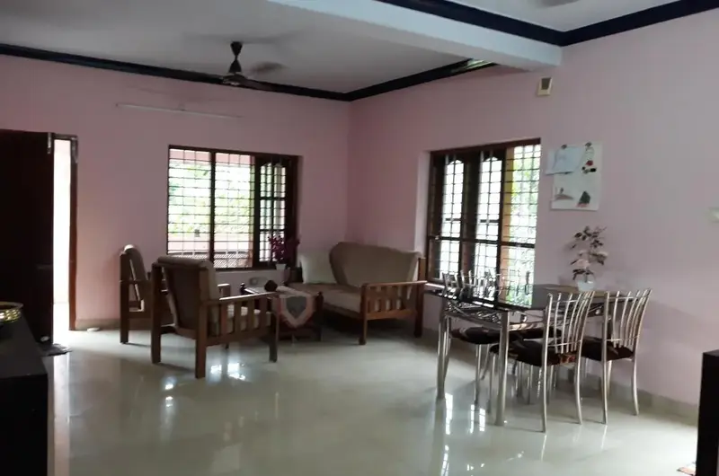 Spacious indoor living room and dining setup at Padmini House Kovalam