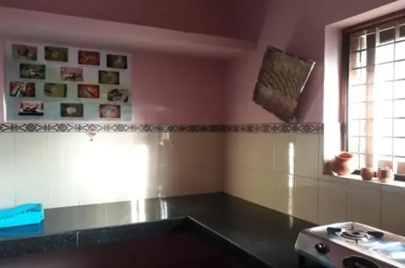 Clean and functional kitchen space interior at Padmini House Kovalam