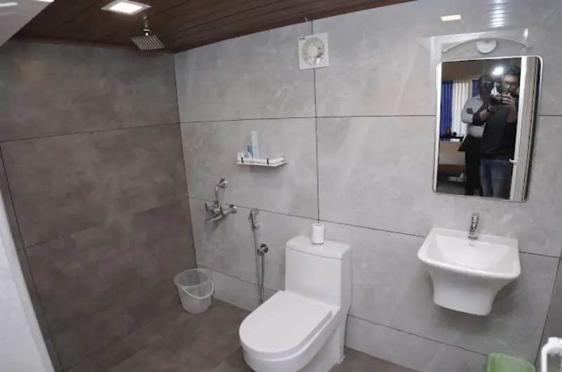 Clean and contemporary resort bathroom with modern fixtures at Country Club Kovalam Beach