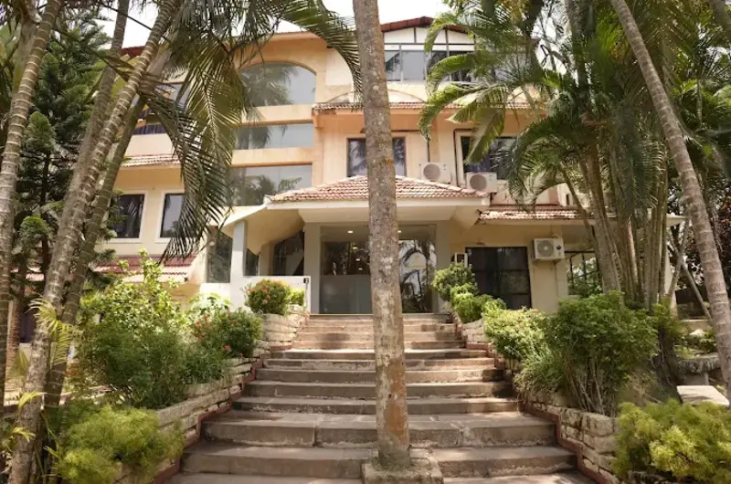 Country Club Kovalam Beach main resort building exterior surrounded by palm trees