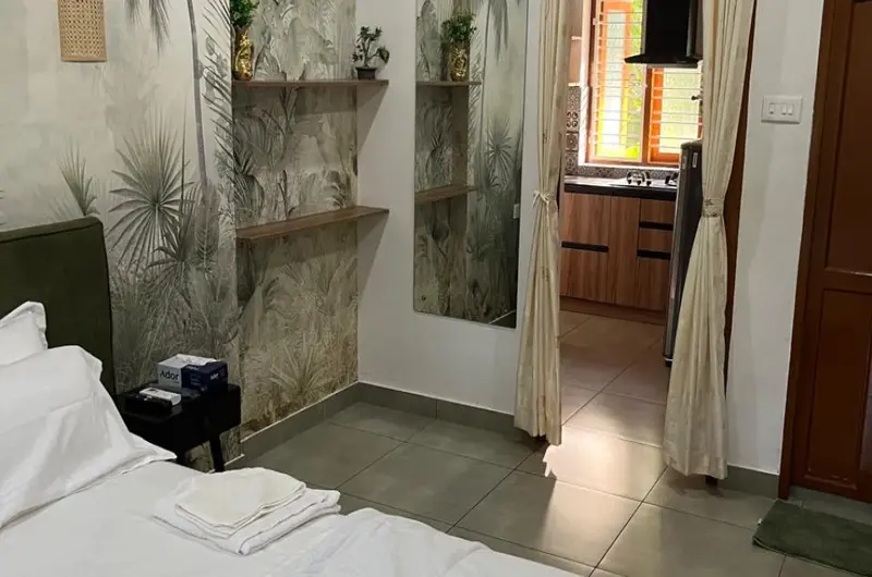 Cozy guest room interior view showing the bedding and layout at Sobha Mandiram Kovalam