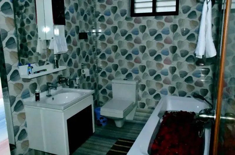 Clean modern bathroom with tiled walls and a glass shower partition