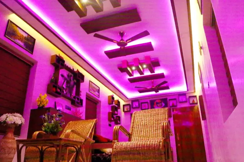 Brightly lit interior hallway with vibrant purple LED ambient lighting at Mary Land Homestay