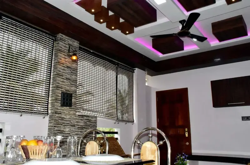 Bright dining area featuring modern false ceiling design and lighting